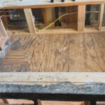 The frame for the bathtub with the old tile removed.