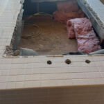 The tub has been removed, next is the old tile.