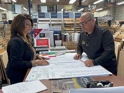 Jackie and Felipe reviewing plans in the showroom.
